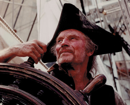 Heston as “Long John Silver” at the wheel, TREASURE ISLAND