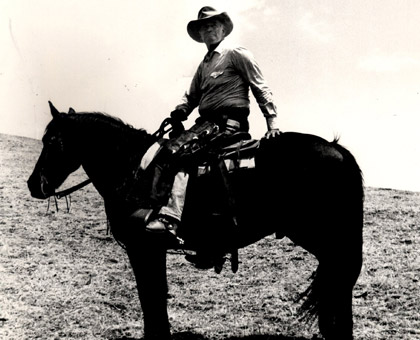 Charlton Heston surveys the ranch.